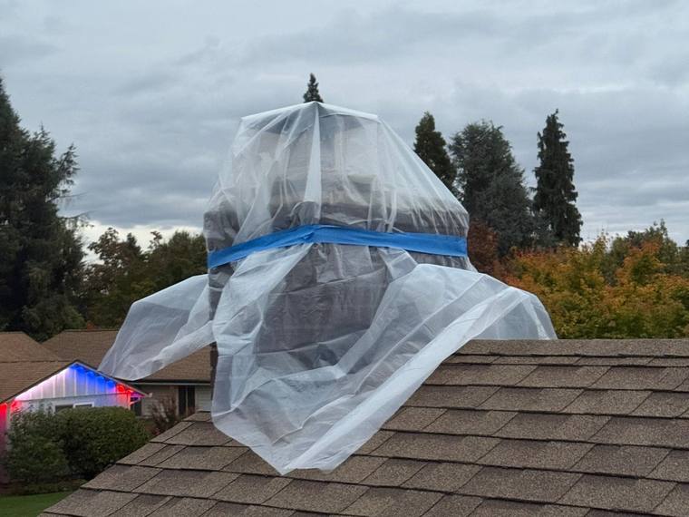 Chimney masonry repair project with protective covering, Forest Fresh Home Solutions.