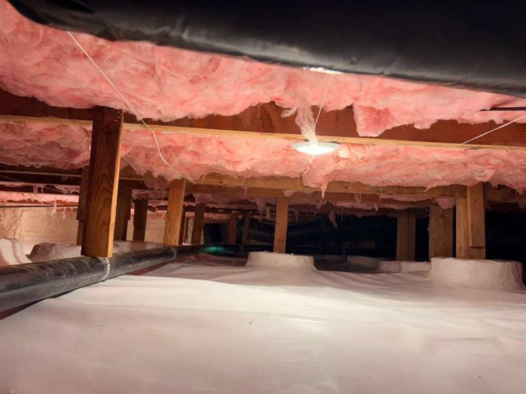 Attic insulation project showcasing pink fiberglass insulation and encapsulation by Forest Fresh Home Solutions.