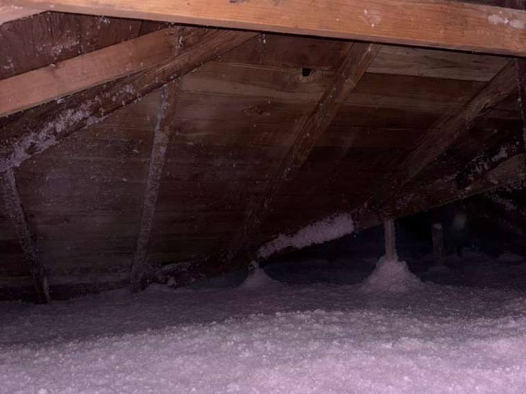 Attic insulation project with blown-in fiberglass insulation by Forest Fresh Home Solutions.