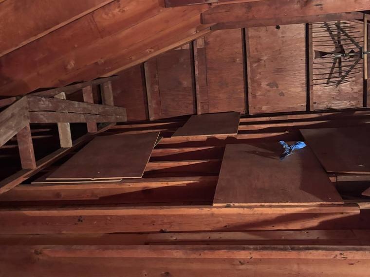 Attic insulation project by Forest Fresh Home Solutions, showing wood framing and insulation boards.
