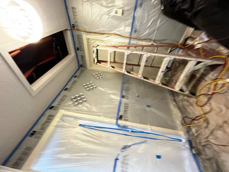 Crawl space encapsulation project with plastic sheeting and ladder, Forest Fresh Home Solutions insulation services.